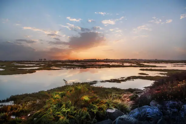 View of Punta Umbria from the marshes of Huelva Spain, in a beautiful sunset with a sky full of clouds