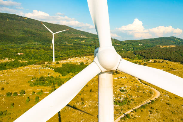 istock Windmill operates against forestry mountains in highland 1368259598
