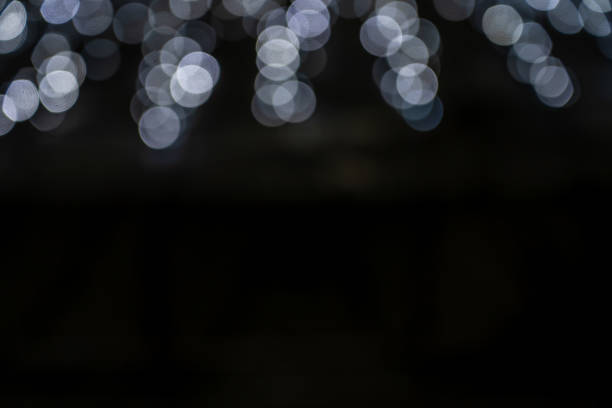 istock White glitter vintage lights with black background. Defocused 1368260614