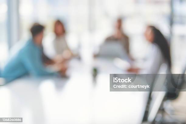 Defocussed Image Of Business People During A Meeting Stock Photo - Download Image Now