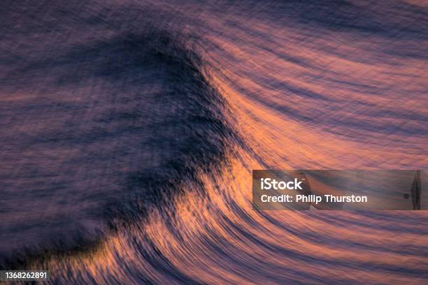 Blurred Motion Of Oceans Surface With Pink And Golden Hues Stock Photo - Download Image Now