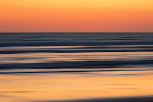 Bright beautiful colors at sunset over the beach, long exposure