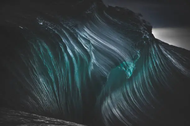 Photo of Full frame teal blue textures of dark ocean wave