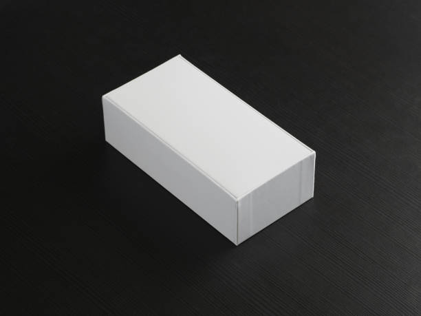 istock Unopened white cardboard phone box on wooden table. 1368264484