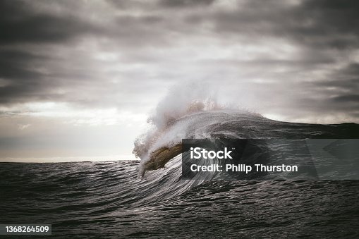 istock Ocean wave forming in front of dark grey skies 1368264509