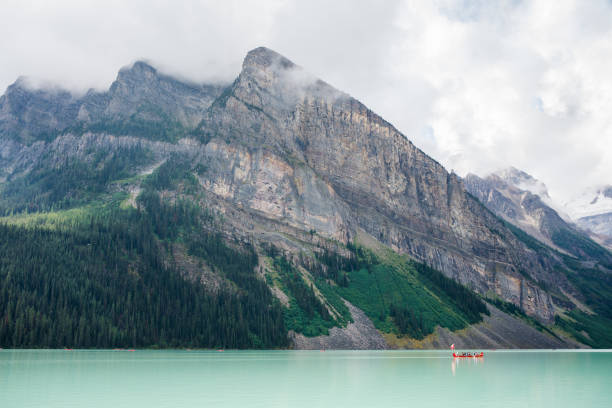 istock Wide angle view of mountain lake and red canoe 1368264533