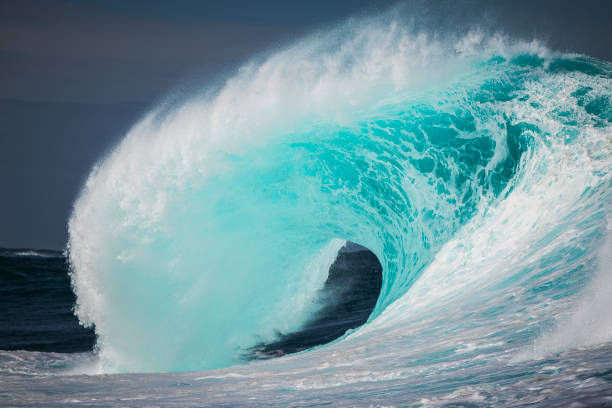 istock Vibrant crystal clear teal blue ocean wave breaking out at sea 1368265499