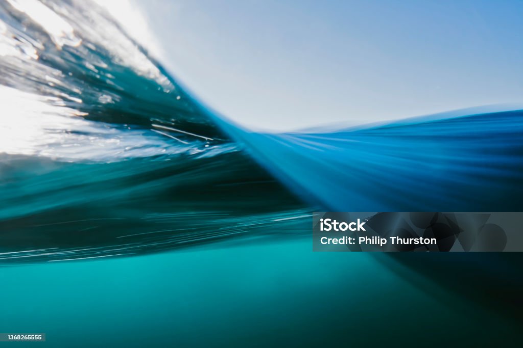 Vortex split view of blue ocean waters surface Vortex split view of blue ocean waters below and above surface Water Stock Photo