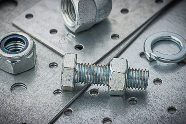 istock Nuts And Bolts On Metal Plate 1368265736