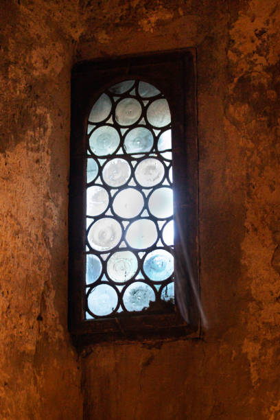 istock Sunlight on a window of medieval architecture. 1368267230