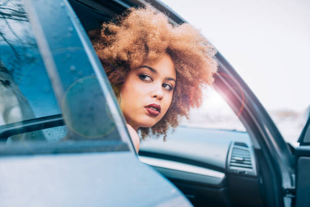 istock Mixed race woman sitting in a car 1368267582