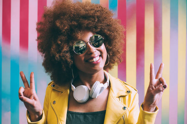 istock Mixed race woman in a colorful artwork background wall 1368267611