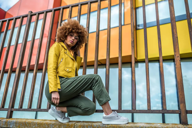 istock Mixed race woman in a multicolor houses background 1368267643