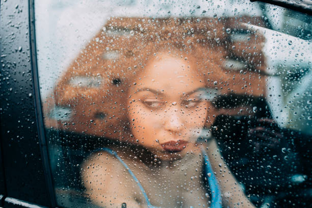 Thoughtful mixed race woman sitting in a car