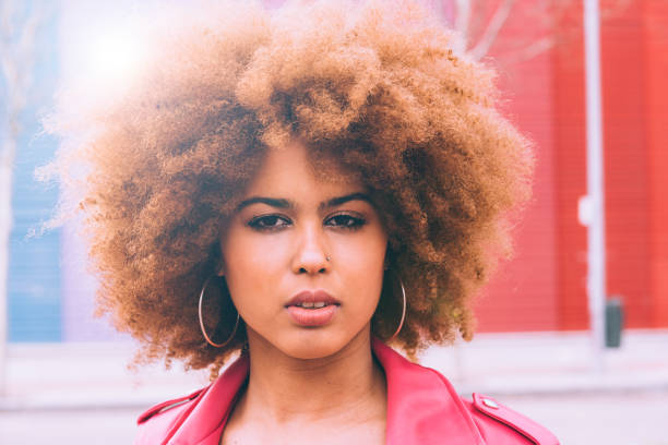 istock Mixed race woman in a multicolor wall background 1368268180