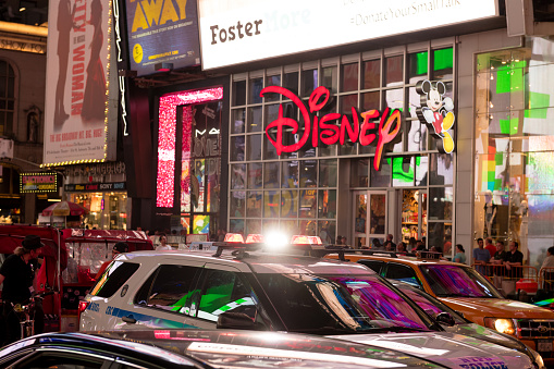 New York, USA - June 6, 2019: NYPD on Broadway passing the disney store early in the evening.