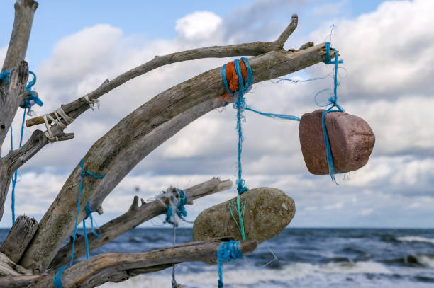 istock A composition of sticks and stones. Installation on the seashore. 1368268821