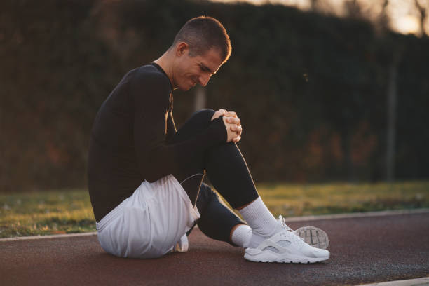 istock A young man is sitting on the treadmill, resting from exercises. 1368269108