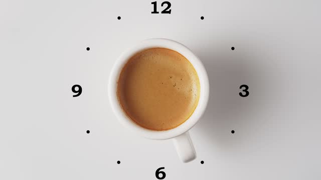 Cup of fresh aromatic coffee with crema, rotate on white background with clock face, top view. Concept of coffee time.