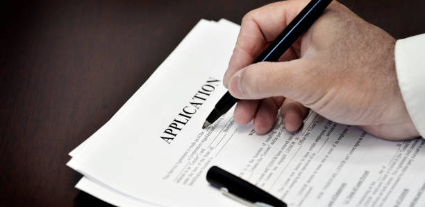istock Loan Contract Document on Desk with Black Pen Application Being Signed 1368270324