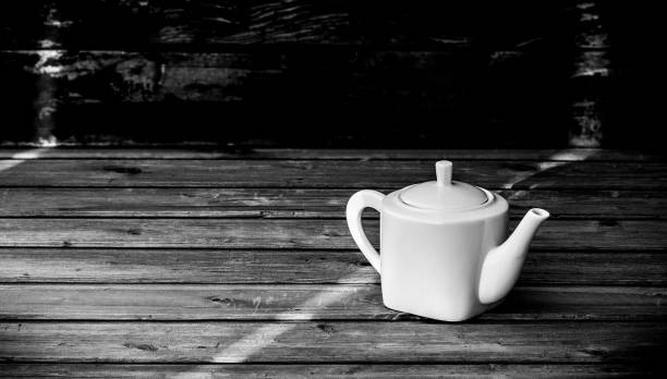 istock White porcelain teapot on wooden background 1368271265