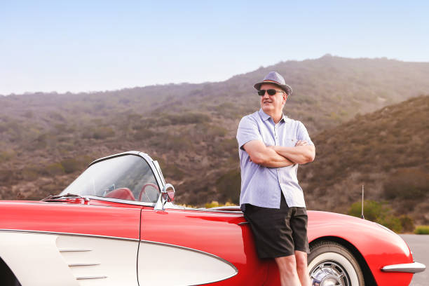 istock Man with his classic sports car 1368271280