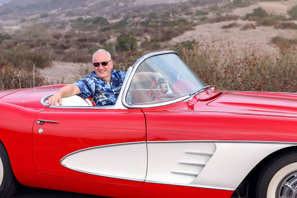 istock Man with his classic sports car 1368271340