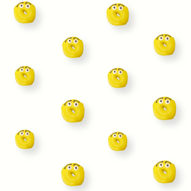 istock Colorful pattern of yellow glazed donuts isolated on white background with shadows. Doughnuts. Top view. Flat lay 1368271712