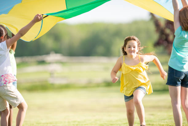 istock Children Running Through a Parachute 1368273964