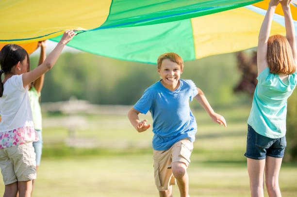 istock Children Running Through a Parachute 1368273970