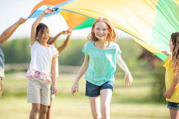 istock Children Running Through a Parachute 1368273977