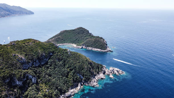 istock Boat sailing towards beach by beautiful peninsula 1368273993