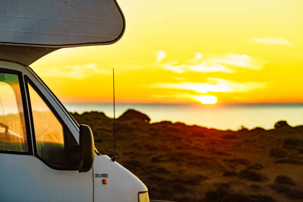 istock Camper vehicle on beach at sunrise 1368274087