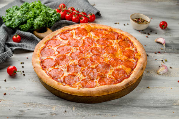 istock Pepperoni pizza on old grey wooden table 1368274112