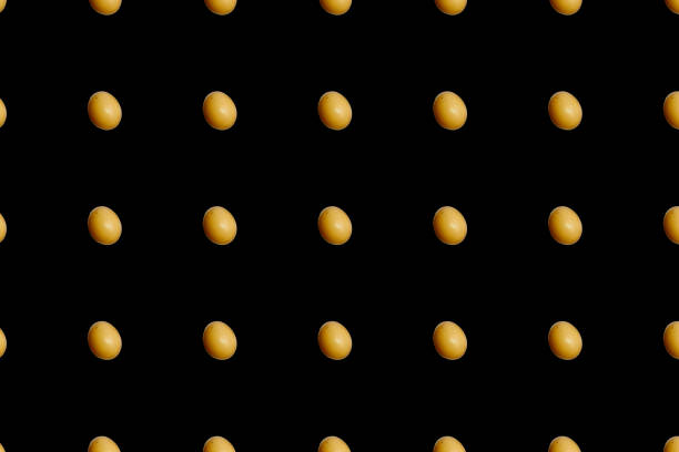 Colorful pattern of chicken eggs on black background. Top view. Flat lay. Pop art design. Seamless pattern with egg