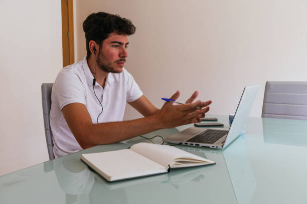 istock Young man having a work call or online class. Concept: teleworking or having online classes. 1368276979