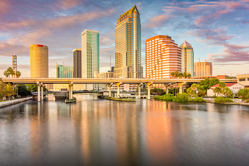 Dramatic skyline of downtown Tampa and the Hillsborough River, Florida, USA at sunset.