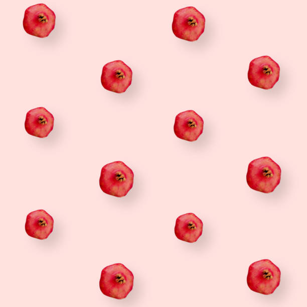 istock Colorful fruit pattern of fresh pomegranates on pink background. Top view. Flat lay. Pop art design 1368280302