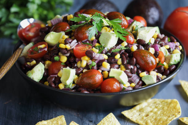 Delicious Mexican black bean and corn salad or Texas caviar bean dip Homemade Mexican black bean and corn salad or Texas caviar bean dip lime dressing, Served with tortilla chips and fresh ingredients. black bean salsa stock pictures, royalty-free photos & images
