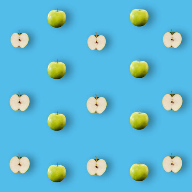 istock Colorful fruit pattern of fresh green apples on blue background with shadow. Top view. Flat lay. Pop art design, creative summer concept 1368280687