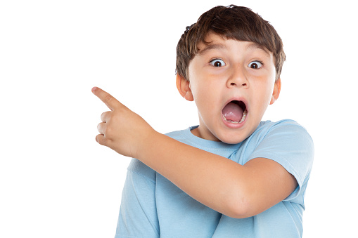 Child kid amazed surprised little boy pointing on ad advertising isolated on a white background
