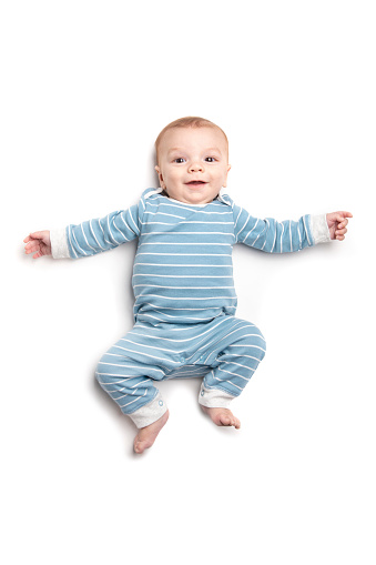 A happy 5 month old baby boy isolated on a white background.