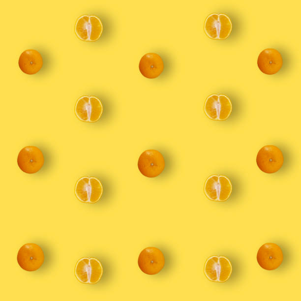 istock Colorful fruit pattern of fresh orange on yellow background with shadows. Top view. Flat lay. Pop art design 1368284754