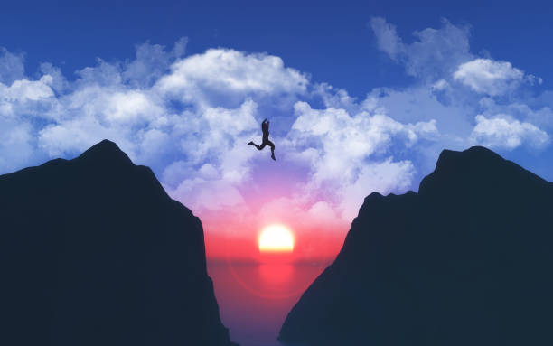istock 3D landscape with male jumping from one mountain to another 1368284857