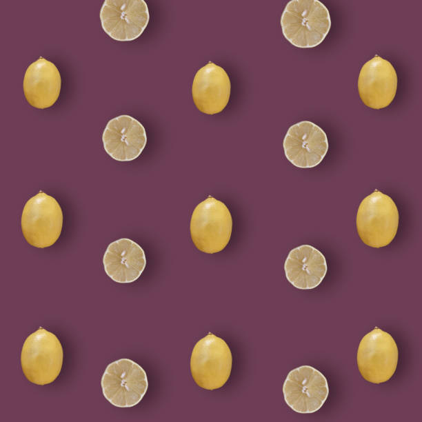 Colorful fruit pattern of fresh lemons on dark purple background. Top view. Flat lay. Pop art design