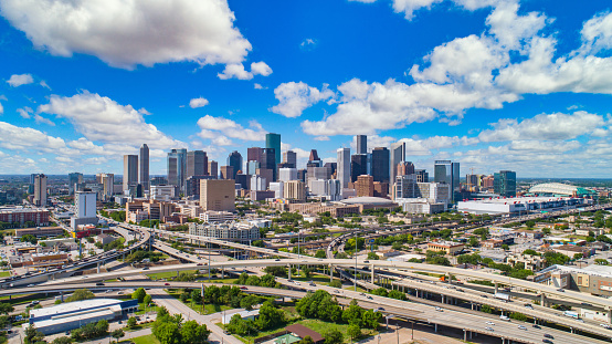 Aerial view of skyscrapers in downtown Houston against cloudy sky, Texas, USA.
