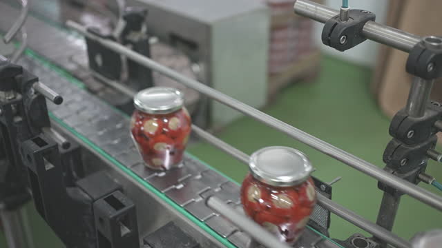Factory Line With Jars Full Of Stuffed Peppers