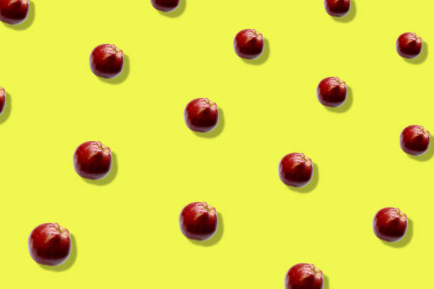 istock Colorful fruit pattern of fresh red apples on yellow background. Top view. Flat lay. Pop art design, creative summer concept 1368286989