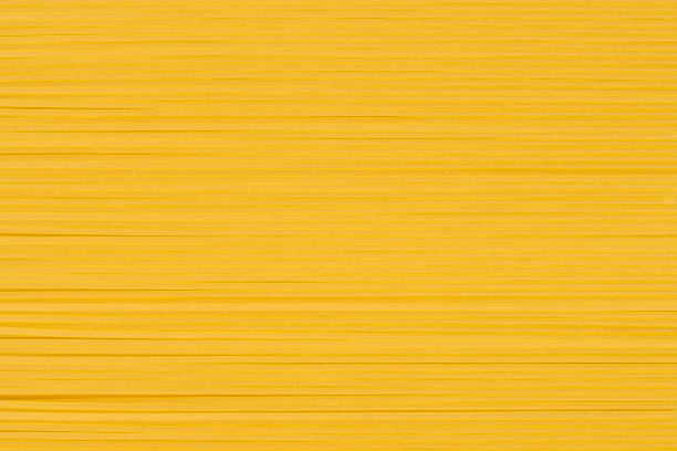 istock Raw thin spaghetti in rows, italian pasta. Food background concept 1368289892