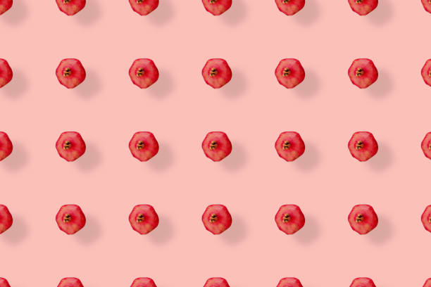istock Colorful fruit pattern of fresh pomegranates on pink background. Top view. Flat lay. Pop art design 1368289957